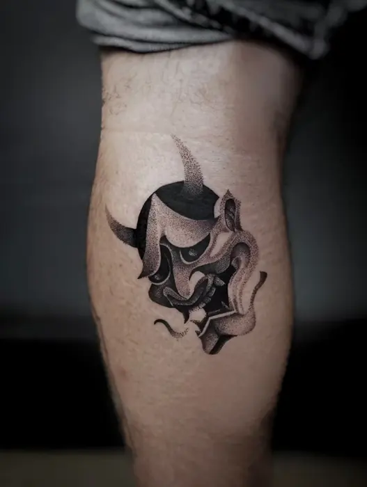 A small hannya mask on the calf in black and grey with a fine red accent.